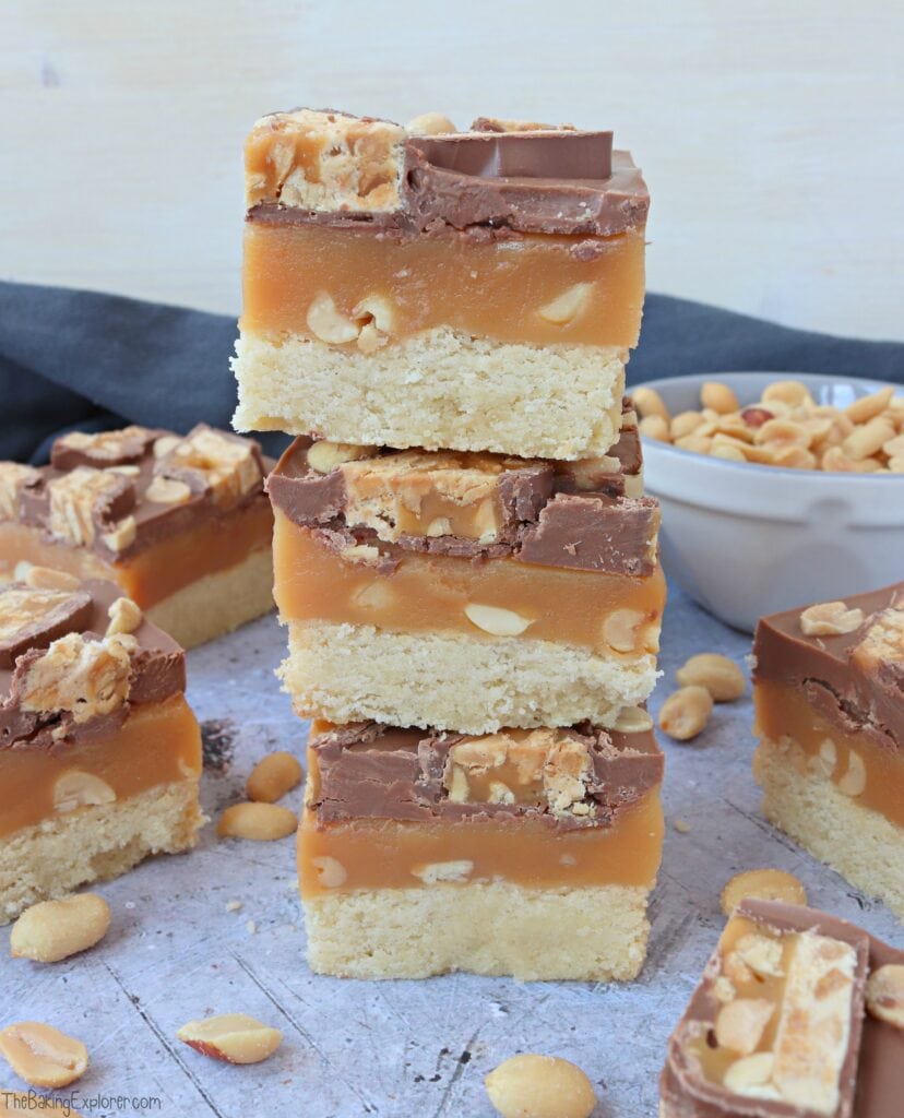 A stack of three pieces of Snickers Millionaire's Shortbread